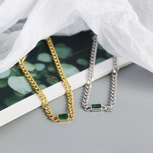 Detail of s925 silver tank chain bracelet featuring a green emerald zircon stone