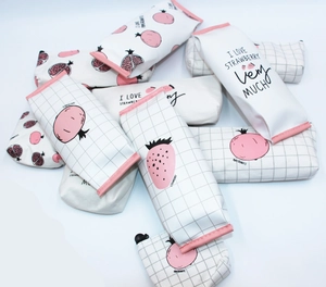 Detailed view of stackable PU pencil cases featuring cute strawberry and grid patterns