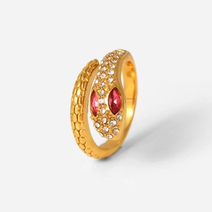 Close-up of 18K gold snake ring featuring red gemstone eyes and sparkling zircon scales
