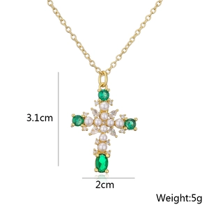 Detailed view of gold cross pendant with pearls and green gemstones including dimensions