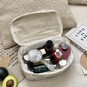 Detailed interior of floral makeup bag showing large capacity storage and mesh pocket