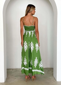 Detail of green backless maxi dress featuring white floral print and elastic waist