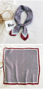 Detail of retro geometric floral silk square scarf in red and blue with styled accessories