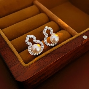 Silver needle gourd earrings with white pearls and zircons in a brown jewelry box