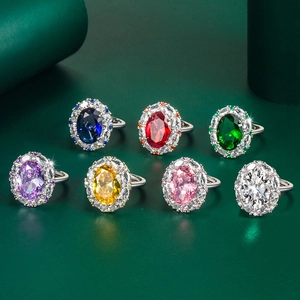 Detail of seven luxury oval-cut gemstone rings in various vibrant colors and silver bands
