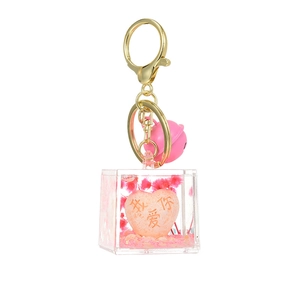 Quicksand acrylic keychain with gold ring, pink bell, and engraved I Love You heart