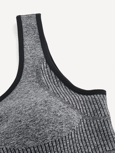 Close-up of grey marl seamless sports bra with ribbed knit details and black elastic trim