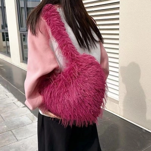 Chic magenta faux fur heart crossbody bag for women shown on a model for autumn winter