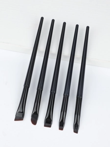 Detailed view of 5 angled and flat blade eyeliner brushes on white minimalist display