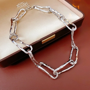 Detailed view of silver textured link chain necklace inside a premium jewelry box