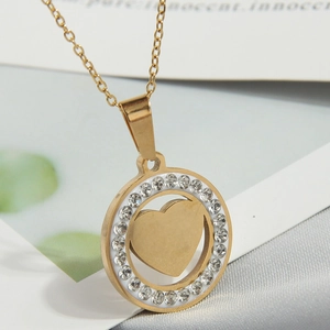 Detailed view of a gold-plated necklace featuring a zircon-encrusted circle and heart pendant