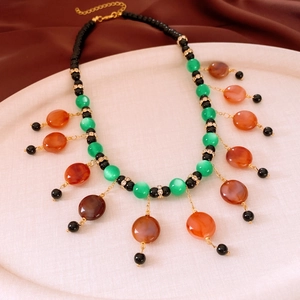Macro detail of vintage colorful glass beads with tassels on a luxury ethnic necklace