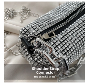 Macro detail of the silver chain strap connector and zipper on the rhinestone bag