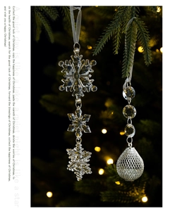 Detail of transparent acrylic snowflake and beaded pendants with white hanging ribbons