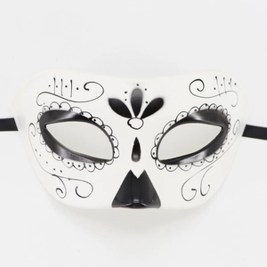 Mexican Day of the Dead half face mask in white with black floral patterns and ties
