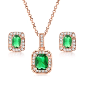 Detailed close-up of emerald green square zircon necklace and earrings jewelry set in rose gold