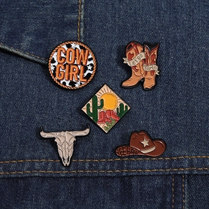Western cowboy enamel pin set featuring skull and cactus on dark blue denim fabric
