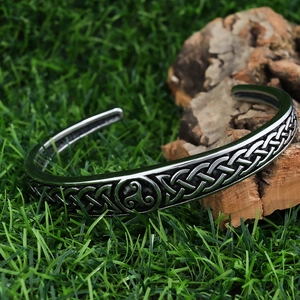 Macro detail of vintage silver cuff bracelet with Celtic knot and Triskele engraving