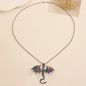 Detail of colorful gradient dragon pendant with rhinestones on a twist chain necklace