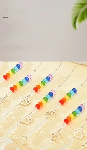 Detailed view of colorful crystal beads and a hollow paw metal pendant on the suncatcher