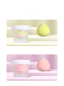 Detail view of pink and yellow peach beauty blenders in frosted storage cups