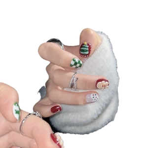 Christmas press-on nails with 3D gingerbread man art and green checkerboard pattern