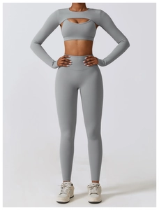 Close-up of grey high-stretch yoga set featuring sports bra, shrug and high-waist pants