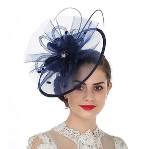 Vintage navy blue mesh fascinator hat with feathers and floral design on model