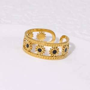Macro shot of gold-plated daisy open ring featuring hollow petals and black oil details