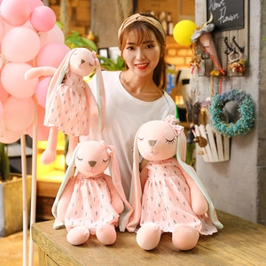Plush long-eared rabbit doll set in soft pink fur, cozy café scene display