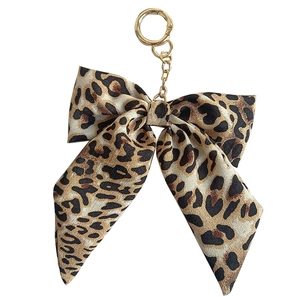 Leopard print bow keychain with fabric ribbon and gold metal ring for bags and car keys