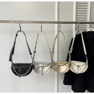 Four half-moon crossbody bags in black, silver, gold, and cream with metal chains
