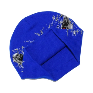 Detailed knit texture of navy blue beanie with abstract eagle jacquard pattern