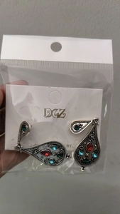 Detail of vintage silver boho earrings with colorful beads in original packaging