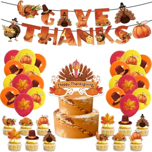 Close-up of Thanksgiving party set with Give Thanks banner and turkey cake toppers