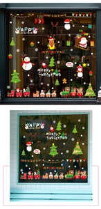 Detailed view of Christmas window decals applied on glass with festive scenery