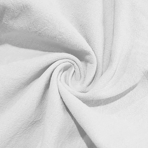 Macro view of white linen fabric texture showing breathable natural fiber details