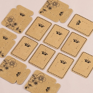 Brown kraft paper crown earring display cards with floral patterns on pink background