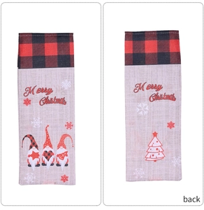 Detail of Christmas wine bottle bags with plaid trim and festive Santa Claus prints