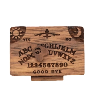 Miniature wooden spirit board with sun, moon, and alphabet symbols for home decor