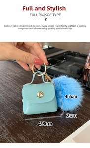Mini light blue crocodile textured bag keychain with blue fur ball and size detail
