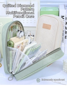 Detail of multi-layer mesh pockets inside a large capacity woven plaid pencil case
