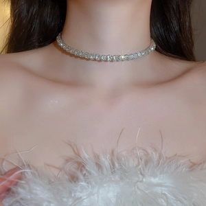 Close-up of sparkling silver choker necklace with clear rhinestones on model's neck