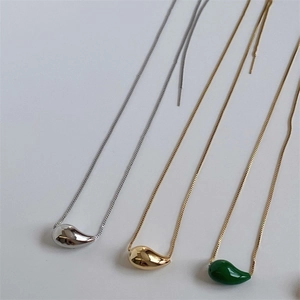 Three teardrop pendant necklaces in gold, silver, and green finishes on box chains