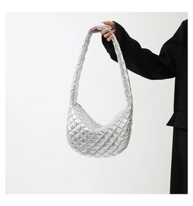 Detail of silver quilted dumpling bag showing the metallic texture and stitching