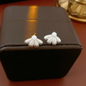 Elegant floral petal pearl stud earrings with a matte silver finish and a vintage design
