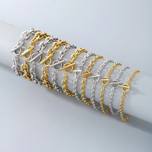 Stack of gold and silver stainless steel O-chain bracelets with OT buckle on display