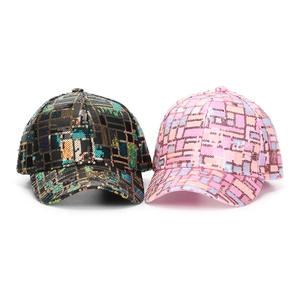 Detail of colorful sequins on baseball caps with black gold and pink purple patterns