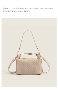 Detail of woven beige leather tote bag featuring a refined metal clasp and shoulder strap