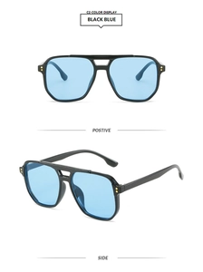 Detail of pilot sunglasses with black frame, light blue lenses and gold rivet accents